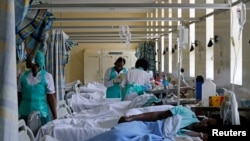 FILE—Medical practitioners attend to a cholera patient inside a special ward at the Kenyatta National Hospital in Nairobi, Kenya, July 19, 2017. 