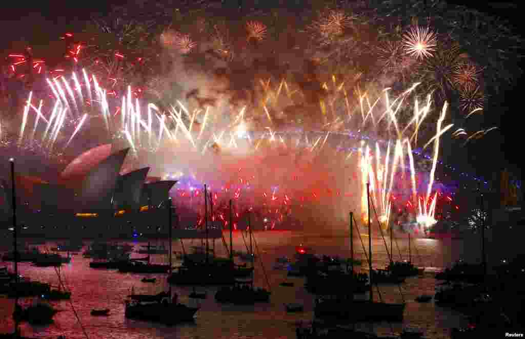 Fireworks light up the Sydney Harbour Bridge and Sydney Opera House during new year celebrations on Sydney Harbour, Australia, Jan. 1, 2018. 