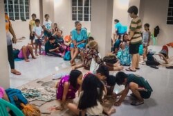 Residents rest in an evacuation center, as Typhoon Phanfone makes landfall, in Borongan, Eastern Samar province, central Philippines, Dec. 24, 2019.