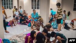 Residents rest in an evacuation centre, as typhoon Phanfone makes landfall, in Borongan, Eastern Samar province, central Philippines, Dec. 24, 2019. 