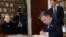 Nobel Peace Prize laureate Colombian President Juan Manuel Santos signs a protocol in the Norwegian Nobel Institute in Oslo, Norway, Dec. 9, 2016. Behind him are Colombian first lady Maria Clemencia Rodriguez and director of the Nobel Institute, Olav Njoelstad. 