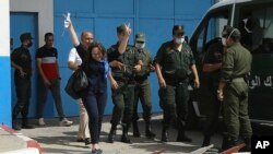 FILE - Activist Amira Bouraoui flashes a victory signs as she is released from prison of Kolea, west of Algiers, Algeria, July 2, 2020.