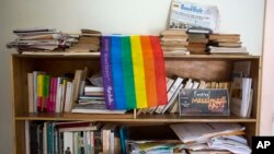 An LGBT pride flag hangs on a bookshelf by a Massimadi festival poster, right, at the the Kouraj organization office in Port-au-Prince, Haiti, Sept. 27, 2016. The four-day Massimadi film, art and performance event was canceled because of threats of violence and a police ban.