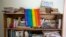 An LGBT pride flag hangs on a bookshelf by a Massimadi festival poster, right, at the the Kouraj organization office in Port-au-Prince, Haiti, Sept. 27, 2016. The four-day Massimadi film, art and performance event was canceled because of threats of violence and a police ban.