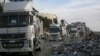 Humanitarian aid trucks enter through the Kerem Shalom crossing from Egypt into the Gaza Strip, as a ceasefire deal between Israel and Hamas went into effect, Jan. 19, 2025.