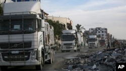 Humanitarian aid trucks enter through the Kerem Shalom crossing from Egypt into the Gaza Strip, as a ceasefire deal between Israel and Hamas went into effect, Jan. 19, 2025.