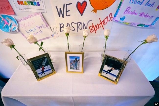 Six white roses and photographs of victims are displayed at The Skating Club of Boston, Jan. 30, 2025, in Norwood, Mass.