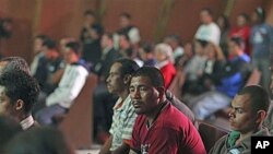 Central American migrants attend a prayer service for missing and killed migrants - trying to cross Mexico to get to the US, who increasingly have become targets of gangs who kidnap them to obtain ransom money - at a migrant shelter in Lecheria, Mexico, J