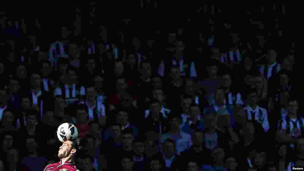 West Ham United&#39;s Andy Carroll heads the ball during their English Premier League soccer match against Newcastle United at The Boleyn Ground in London May 4, 2013.