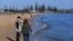 People enjoy the sunshine, as Victoria state begins easing coronavirus disease (COVID-19) restrictions, at Elwood beach in Melbourne, Australia, Sept. 14, 2020. (AAP Image/James Ross via Reuters) 