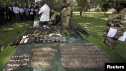 Kenya wildlife officials display firearms recovered from elephant poachers at their headquarters, Nairobi, June 22, 2012.