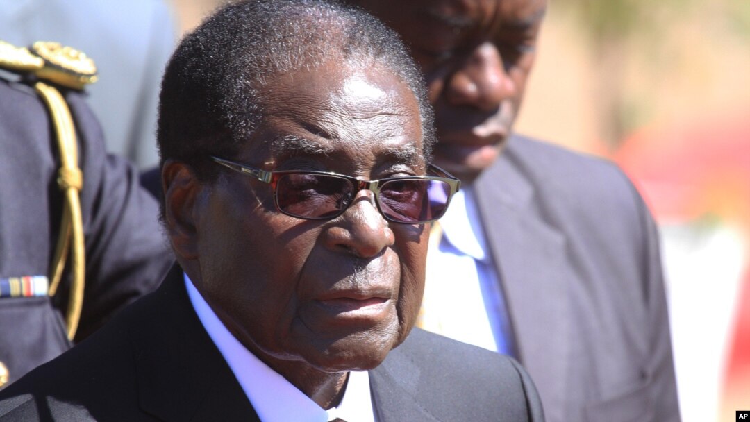 FILE - Zimbabwean President, Robert Mugabe, attends the burial of Major General Bandama who died after a short illness at the National Heroes acre in Harare, July, 17, 2014.