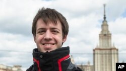 FILE - Nikolai Podchasov, a student at the Lomonosov Moscow State University, poses for a photo in front of the university during his interview with Associated Press in Moscow, Russia, April 23, 2015.