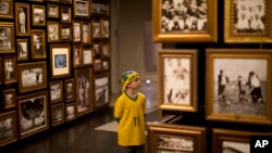 In this June 12, 2014 photo, a young Brazil soccer fan visits the Hall of Origins at the Soccer Museum in Sao Paulo, Brazil.