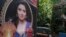 Indian policemen guard near a picture of Indian actress Sridevi displayed outside her residence in Mumbai, India, Feb. 27, 2018.
