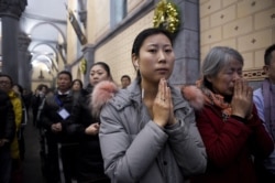 Chinese Christians attend Christmas Eve mass at a Catholic church in Beijing, on Dec. 24, 2016.