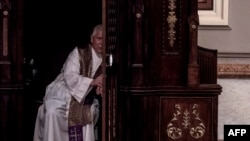 FILE - A priest hears a confession at the Metropolitan Cathedral in San Jose, Costa Rica, June 02, 2019. 