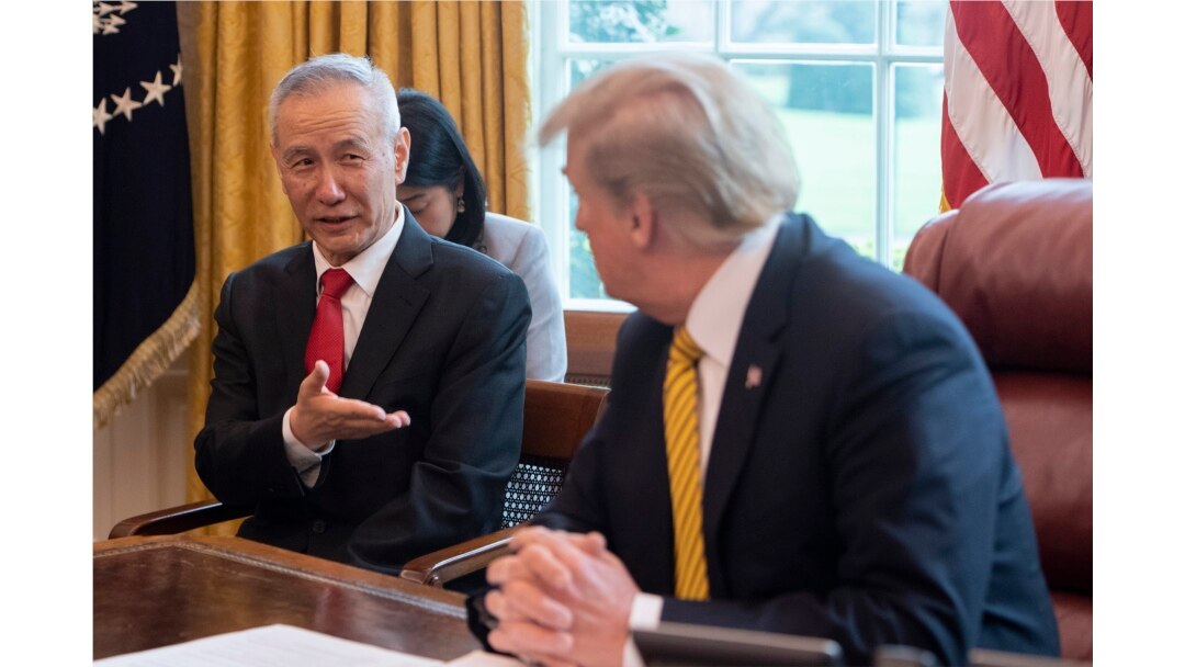 FILE - China's Vice Premier Liu He speaks with U.S. President Donald Trump during a trade meeting in the Oval Office at the White House in Washington, April 4, 2019.