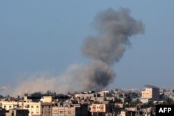 FILE—A picture taken from Rafah shows smoke billowing over Khan Younis in the southern Gaza Strip during Israeli bombardment on March 4, 2024, amid ongoing battles between Israel and the Palestinian militant group Hamas.