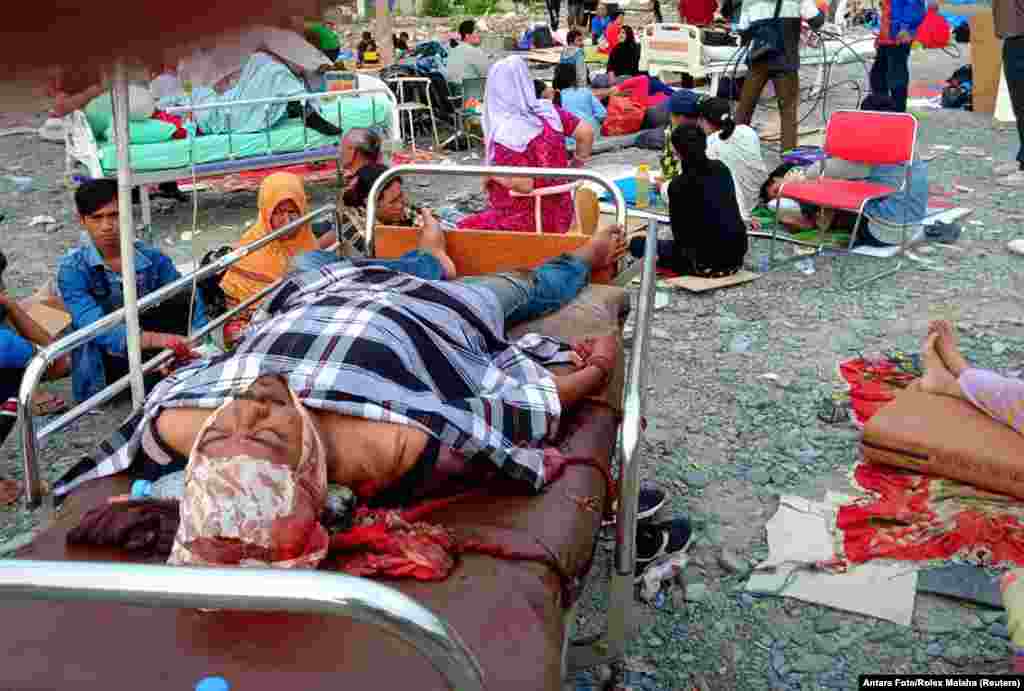 Earthquake survivors rest on beds outside a hospital in Palu, Sulawesi Island, Indonesia, Sept. 29, 2018.