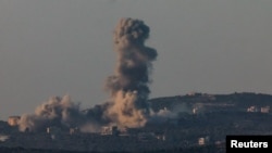 Smoke billows over Rmyach, southern Lebanon, as seen from Sasa