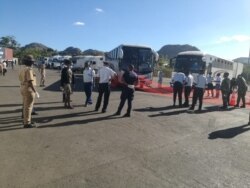 Immigration officers at Mwanza border wellcoming buses carrying Malawi returnees. (Courtesy: Pasqually Zulu/Immigration Department)