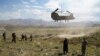 (FILES) In this file photo taken on June 6, 2019 a US military Chinook helicopter lands on a field outside the governor's palace during a visit by the commander of US and NATO forces in Afghanistan, General Scott Miller, and Asadullah Khalid, acting…