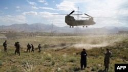 In this file photo taken on June 6, 2019, a U.S. military Chinook helicopter lands on a field during a visit by the Gen. Scott Miller, commander of U.S. and NATO forces in Afghanistan.