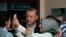 FILE - Turkish President Recep Tayyip Erdogan poses for selfie photograph with woman after voting at a polling station in Istanbul, June 7, 2015.