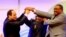 FILE - Sudanese President Omar al-Bashir, center, Egyptian President Abdel-Fattah el-Sissi, left, and Ethiopian Prime Minister Hailemariam Desalegn, right, hold hands after signing an agreement on sharing water from the Nile River, in Khartoum, Sudan, March 23, 2015.