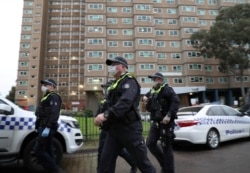 Police officers enforce a lockdown at public housing towers in response to an outbreak of the coronavirus disease in Melbourne, Australia, July 4, 2020.