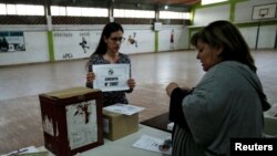 Electoral workers prepare a polling station in El Cerro, Montevideo, Uruguay, Oct. 27, 2019. 