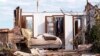 A tornado-damaged bedroom with clothes hanging in the closet is pictured in Oklahoma City, Oklahoma May 22, 2013. 