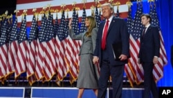 Republican presidential nominee former President Donald Trump, Melania Trump and Barron Trump, arrive to speaks at an election night watch party, Nov. 6, 2024, in West Palm Beach, Fla.