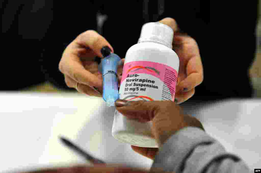 FILE - A mother gets an antiretroviral (ARV) drugs at the Chris Hani Baragwanath Hospital, South Africa's largest public hospital, in Soweto.
