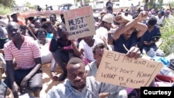 Detainees, now forced to sleep outside their detention center, protested over the weekend, secretly sending pictures to journalists calling for their evacuation to safer countries. Photographed and transmitted to VOA July 7, 2019, in Tripoli, Libya.