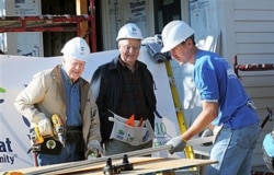 Former President Jimmy Carter, left, former Vice President Walter Mondale, center, and Minneapolis Mayor R.T. Rybak work together with volunteers with Habitat For Humanity to repair an old home in Minneapolis, Minn., Oct. 6, 2010.