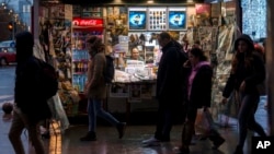 People walk by a newspaper stand after the Constitutional Court annulled the first round of the country's presidential election in Bucharest, Romania, Dec. 6, 2024.