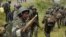 Congolese soldiers move to frontline positions as they advance against the M23 rebels in Kibumba, north of Goma October 27, 2013. REUTERS/Kenny Katombe (DEMOCRATIC REPUBLIC OF CONGO - Tags: MILITARY POLITICS CIVIL UNREST CONFLICT) - RTX14QPU