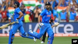 India’s Virat Kohli, right, runs to complete his hundred runs during the World Cup Pool B match against Pakistan in Adelaide, Australia, Feb. 15, 2015.