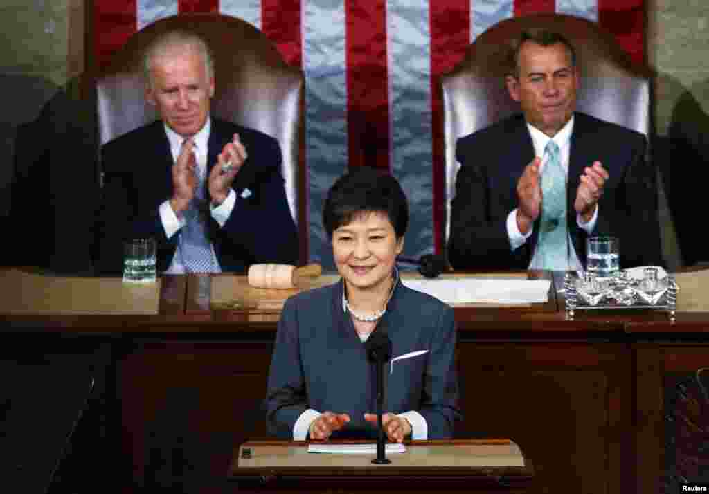 US Vice President Joe Biden and Speaker of the House John Boehner applaud South Korea President Park Geun-hye after she addressed a joint meeting of Congress in Washington, May 8, 2013.