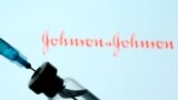 FILE - A vial and sryinge are seen in front of a displayed Johnson&Johnson logo in this illustration taken Jan. 11, 2021.