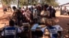 Officials from the Electoral Commission in Ghana check voters' IDs at a polling station in Walewale on Dec. 7, 2024, during the Ghana presidential and parliamentary elections.