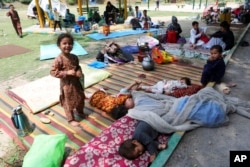 FILE - Afghan children slumber  successful  an country  wherever  displaced radical   person  enactment     up   makeshift tents portion    they question    asylum from the U.N. High Commissioner for Refugees extracurricular  the Islamabad Press Club successful  Islamabad, Pakistan, May 9, 2022.