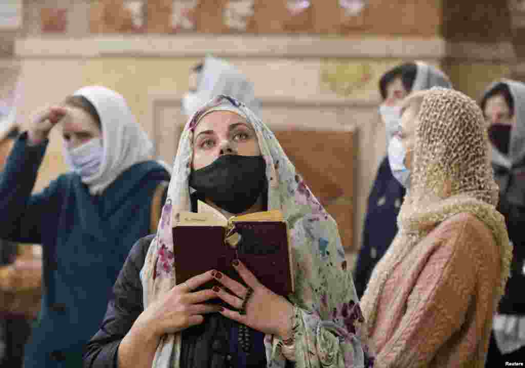 Believers wearing protective face masks attend the Orthodox Easter service at the Kazan Cathedral amid the coronavirus disease (COVID-19) outbreak in Stavropol, Russia.