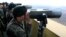 South Korean soldiers look at North Korea through binoculars from Dora Observation Post near the border village of Panmunjom, April 10, 2013.