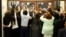 People rush the doors of the jury assembly room as former President Barack Obama departs after being dismissed from jury duty in the Daley Center, Nov. 8, 2017, in Chicago. 
