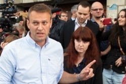 FILE - Russian opposition activist Alexei Navalny (L) and his spokeswoman Kira Yarmysh (C) walk in Kostroma, Russia.