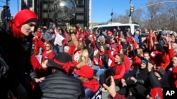 Demonstrators at the International Women's Day rally stage a sit-down protest outside Trump International Hotel at Columbus Circle, March 8, 2017, in New York.