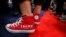 FILE - A supporter of Donald Trump wears a slogan on his sneakers as he attends opening of the Republican National Convention in Cleveland, Ohio, U.S., July 18, 2016. 